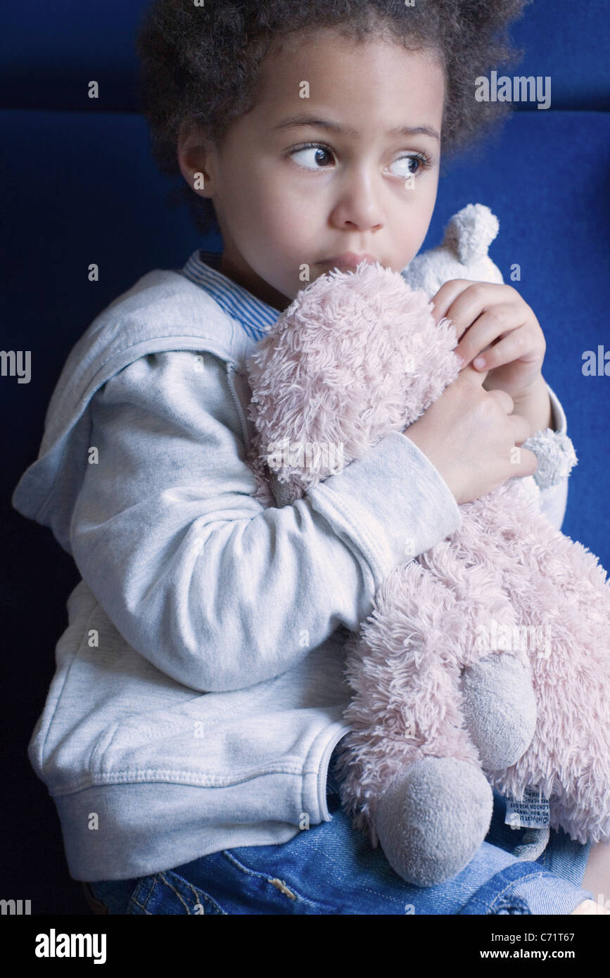 Little girl holding stuffed toy, portrait Stock Photo - Alamy