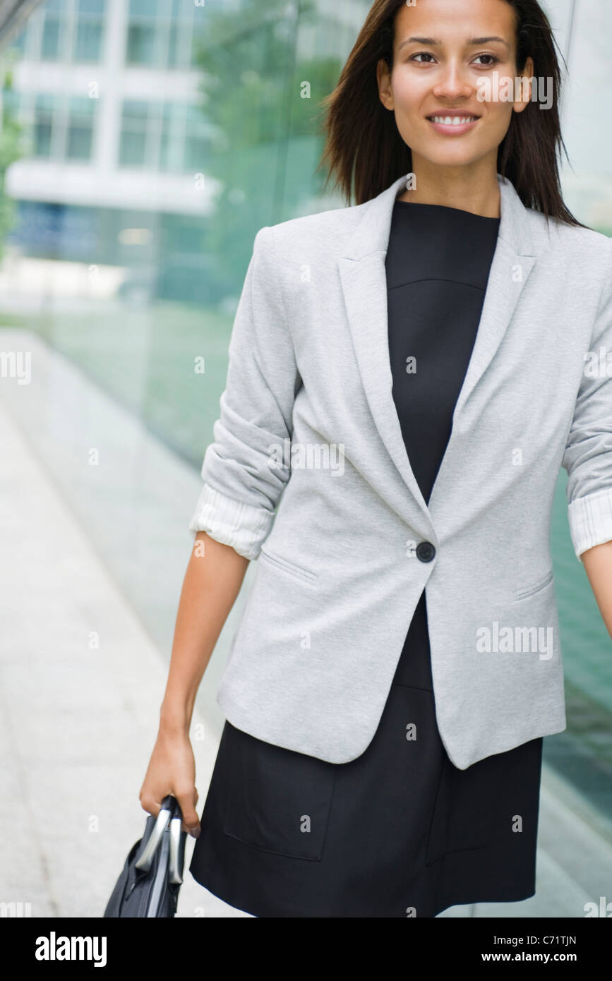 Woman walking with briefcase Stock Photo Alamy