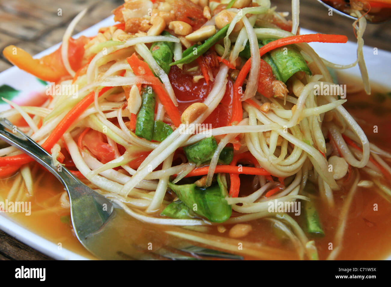 plate of Thai papaya salad also known as som tam Stock Photo