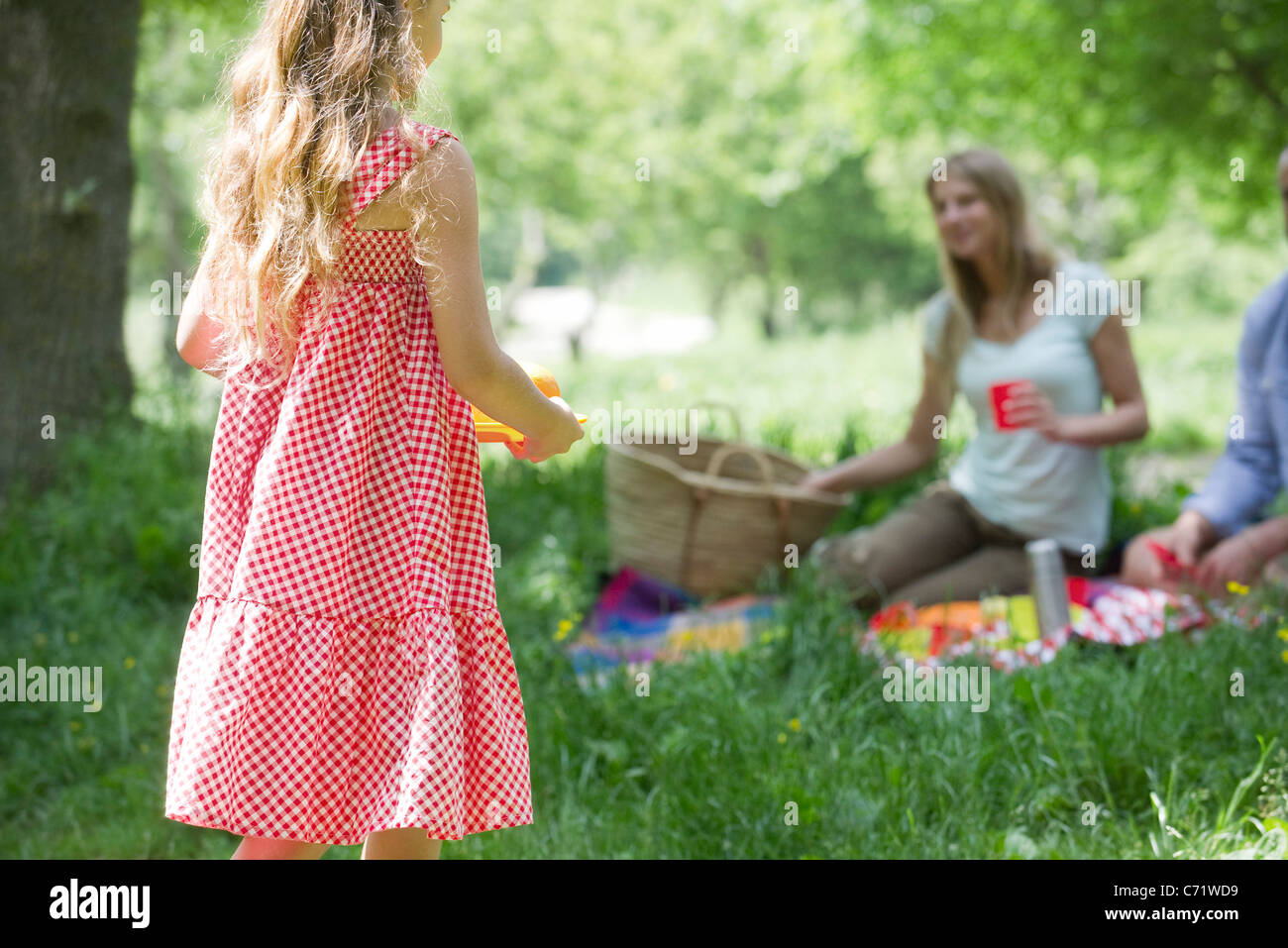 Little girl having picnic with family Stock Photo - Alamy