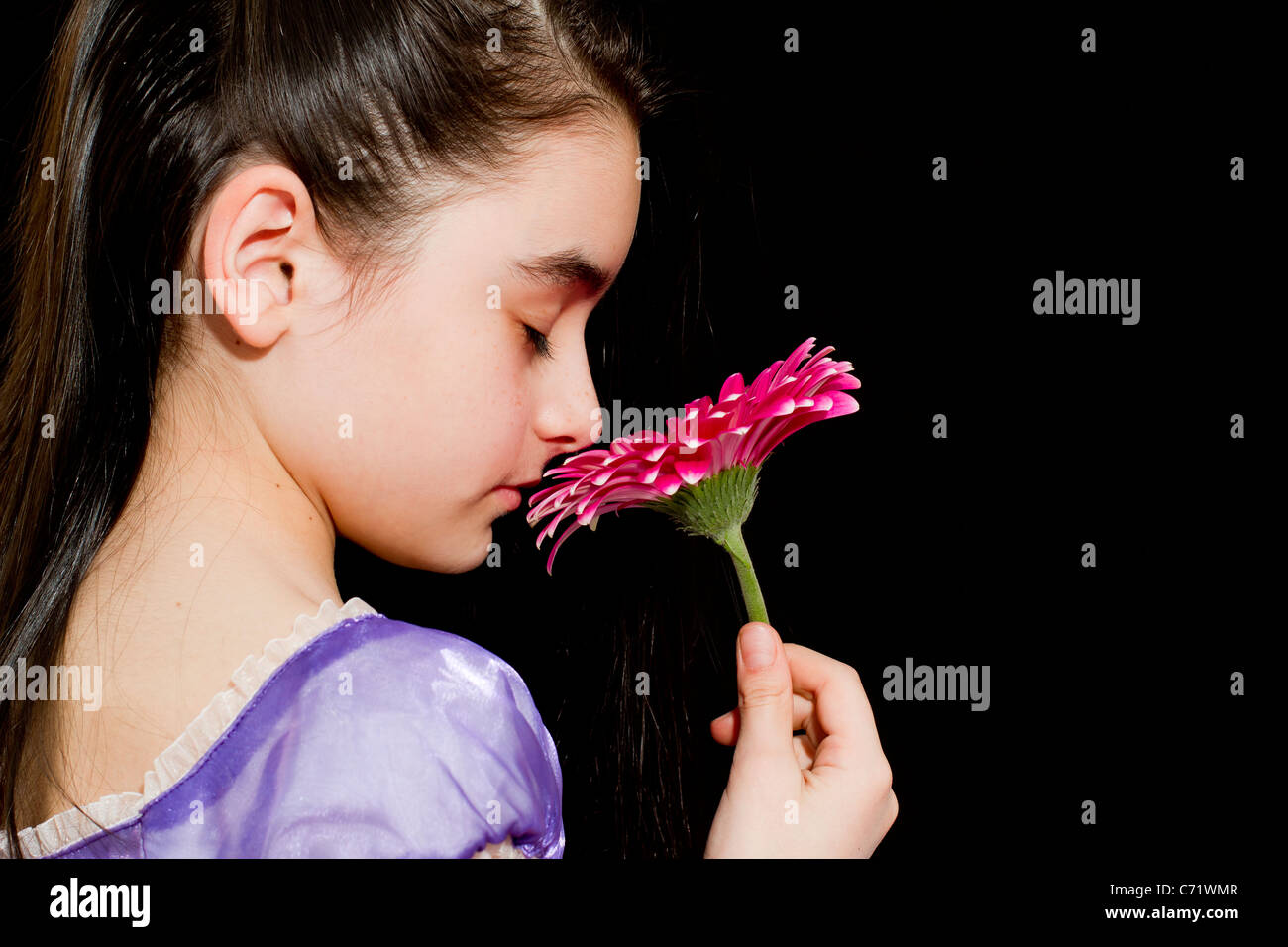 Little girl smells a flower Stock Photo - Alamy