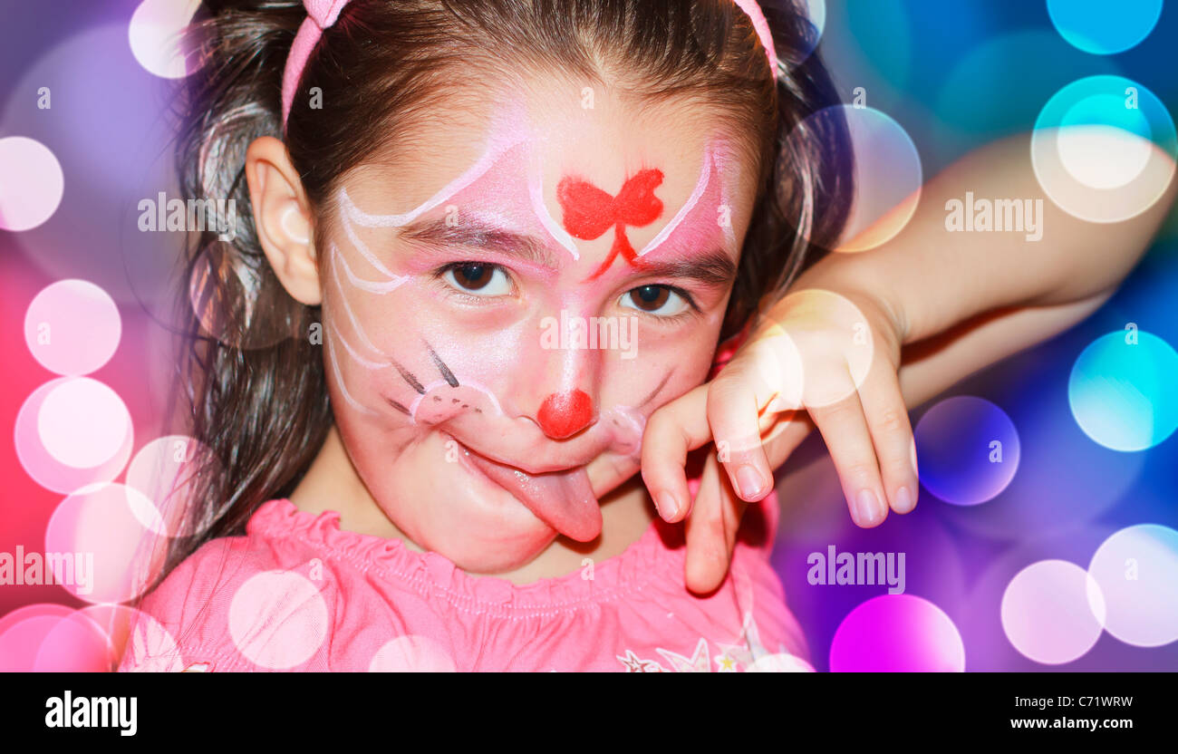 A happy young girl with face-paint on after a carnival Stock Photo