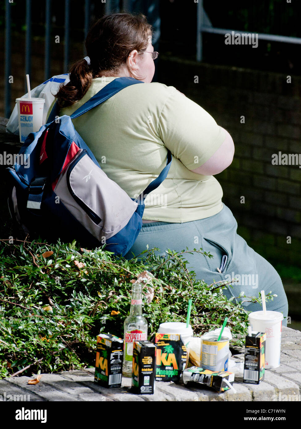 An Obese Woman Rests On A Wall On Her Way To The Notting Hill