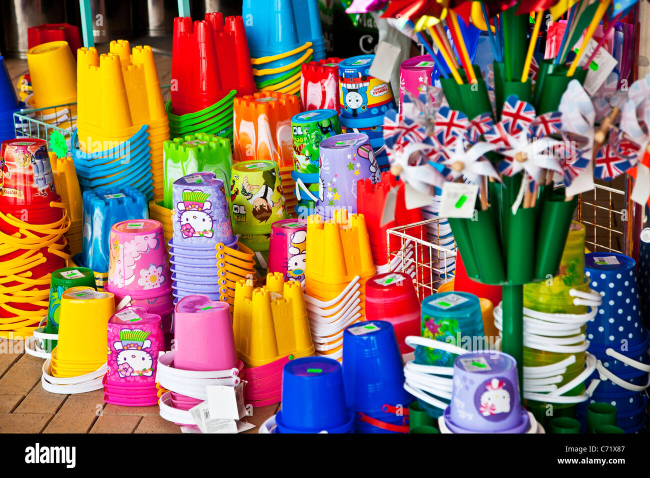 Brightly coloured children's plastic beach toys and buckets on display