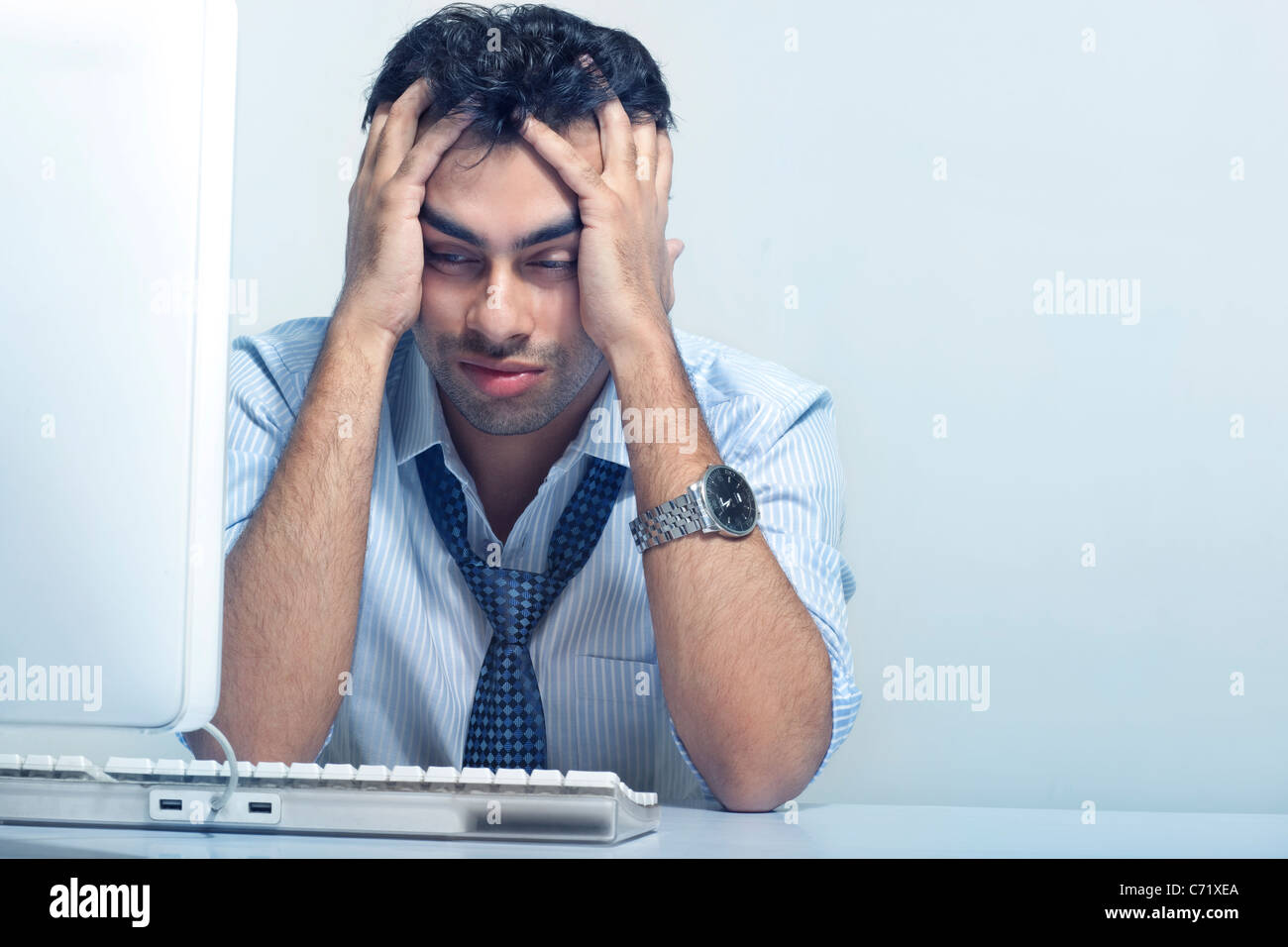 Businessman stressed at work Stock Photo
