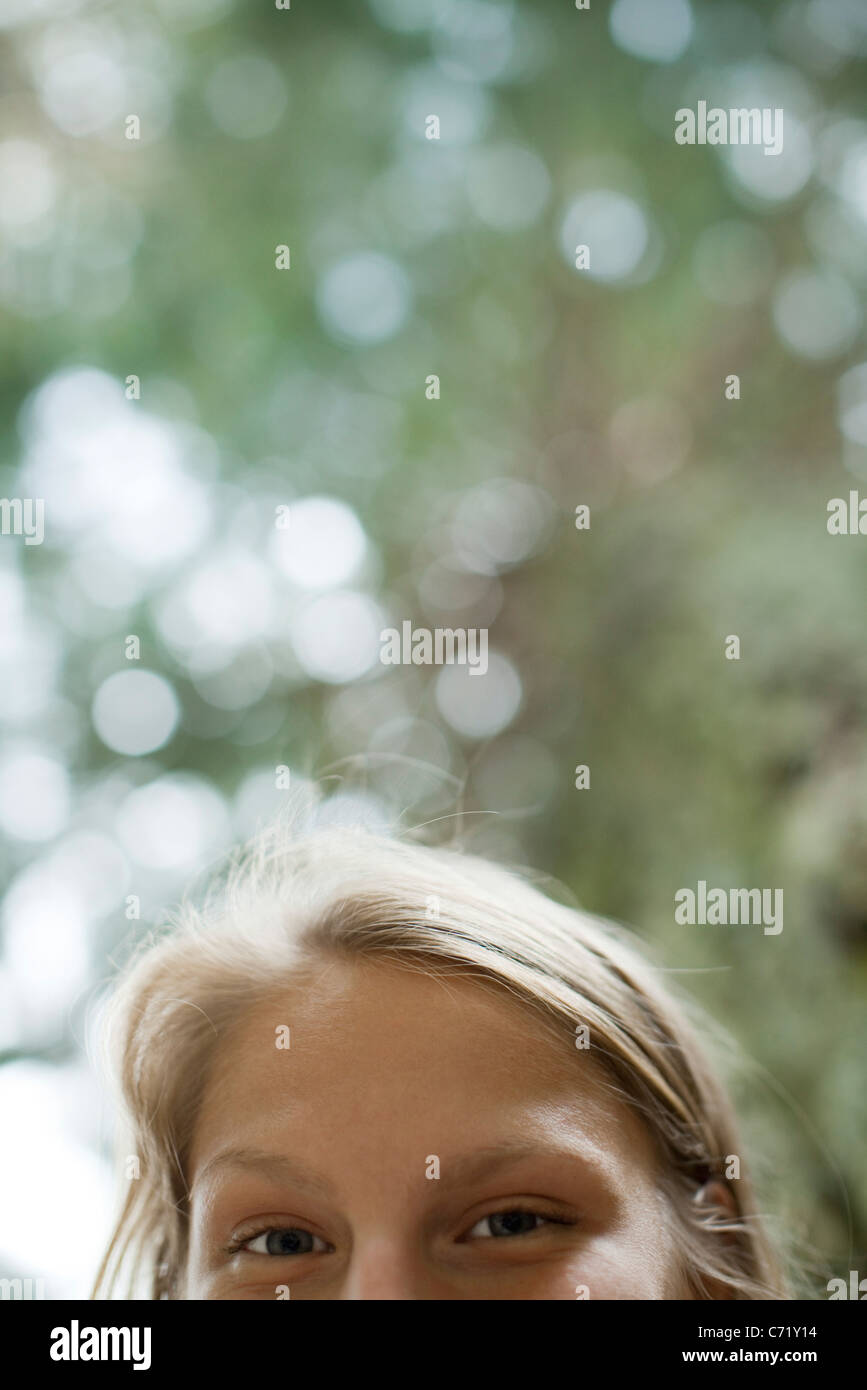 Woman looking down at camera, cropped Stock Photo