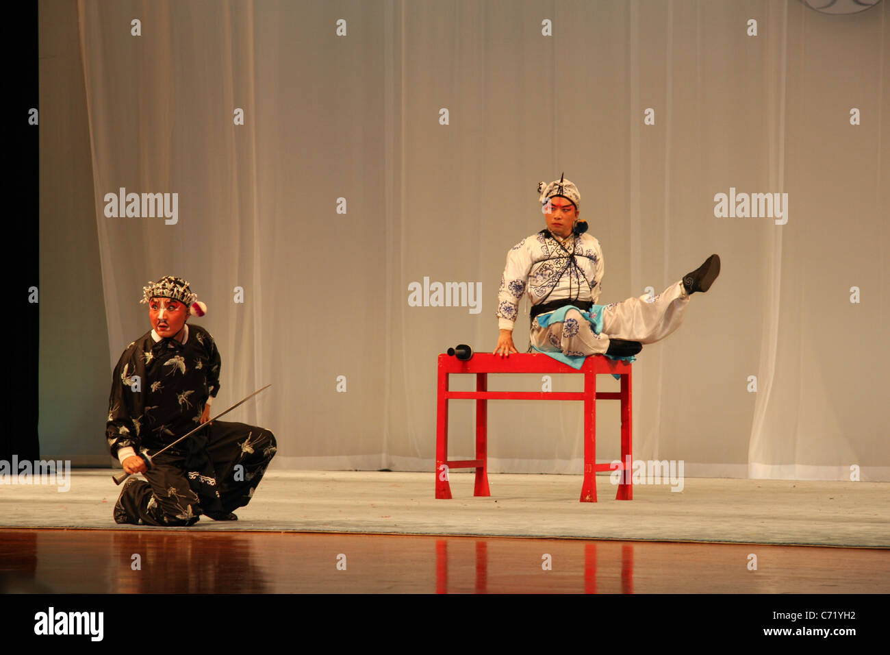 Two men in traditional costumes with swords perform at the Beijing ...