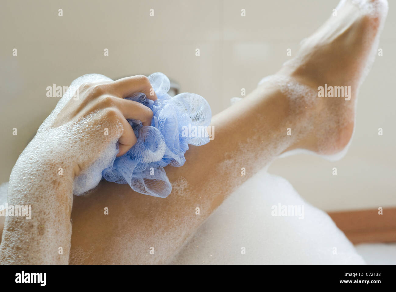 Woman washing leg in bath, cropped Stock Photo Alamy