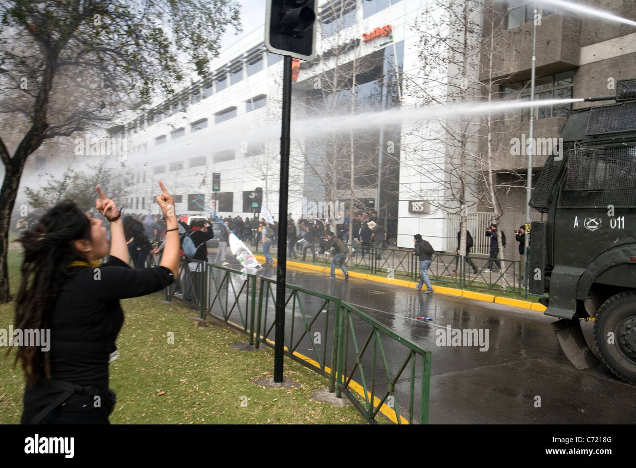 A young girl is reacting against the police decision to disperse the student protest with water cannons, Santiago de Chile Stock Photo