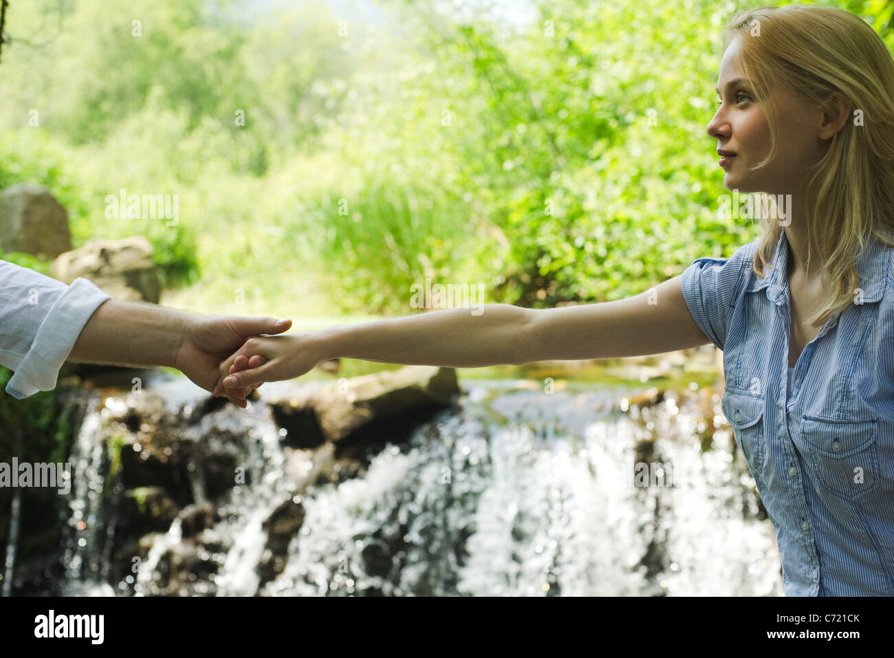Young man woman holding hands hi-res stock photography and images - Alamy
