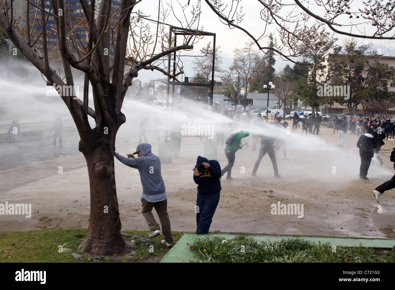 Water cannon against students demonstrating in Santiago de Chile Stock Photo