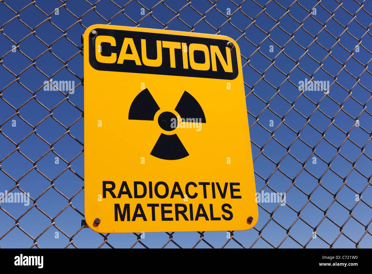 A radioactive materials sign on a fence. Stock Photo