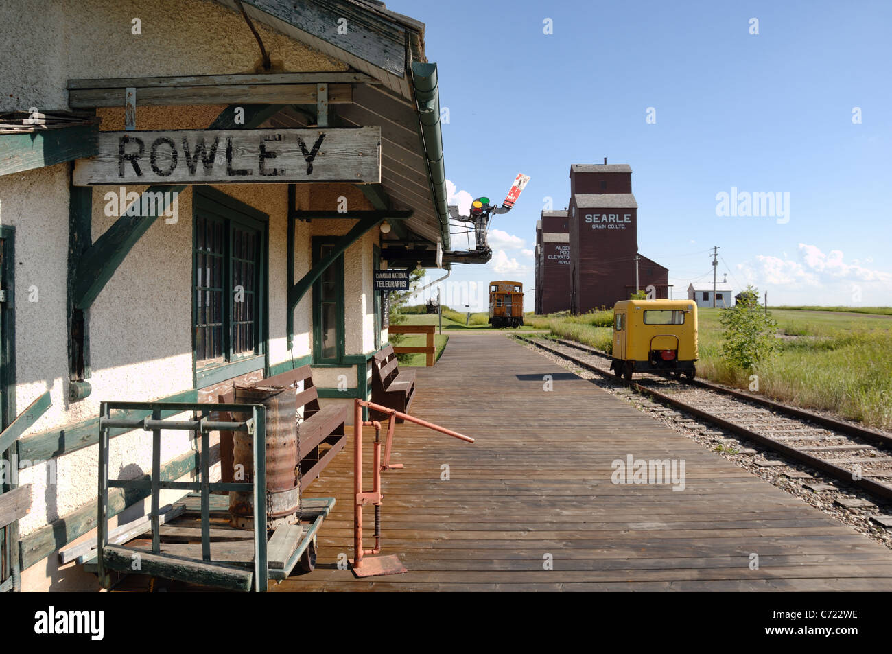 Train station with grain elevators in background at Rowley, Alberta, Canada. Stock Photo