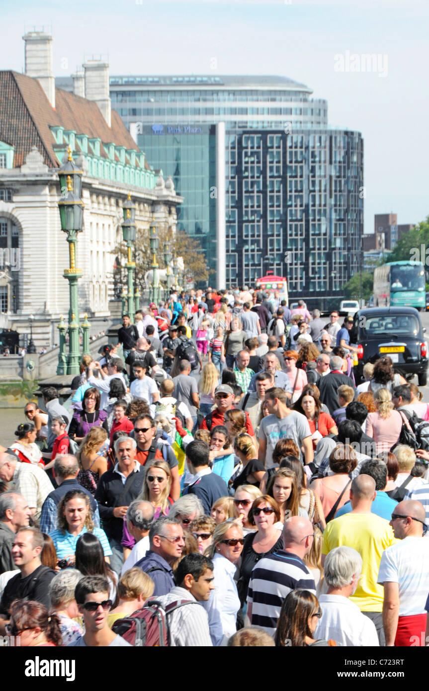 Summer season crowded street scene aerial view looking down from above on crowds of sightseeing tourism people on Westminster Bridge London England UK Stock Photo