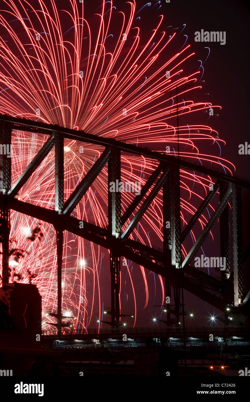 Silhouette of fireworks display behind Sydney Harbour Bridge on New Years eve. Stock Photo
