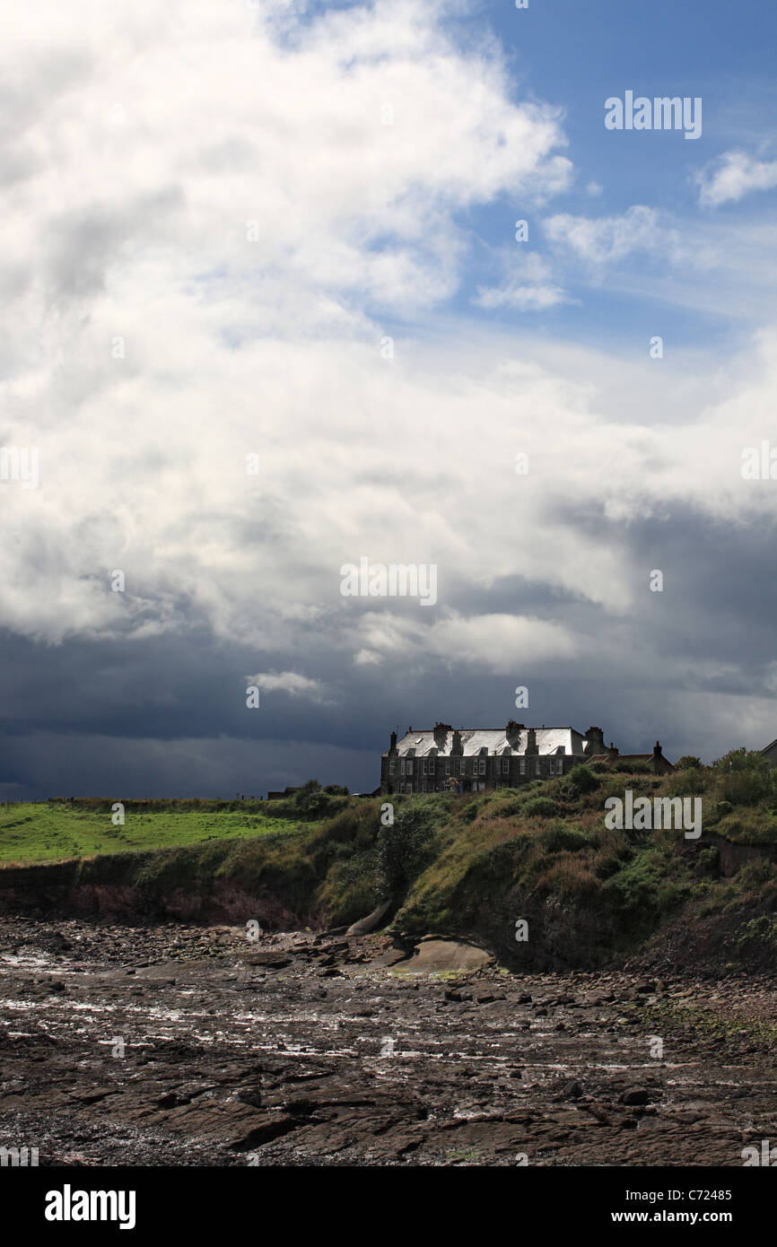 Stormy sky with remote row of houses Crail, East  Fife coast, Scotland, UK Stock Photo