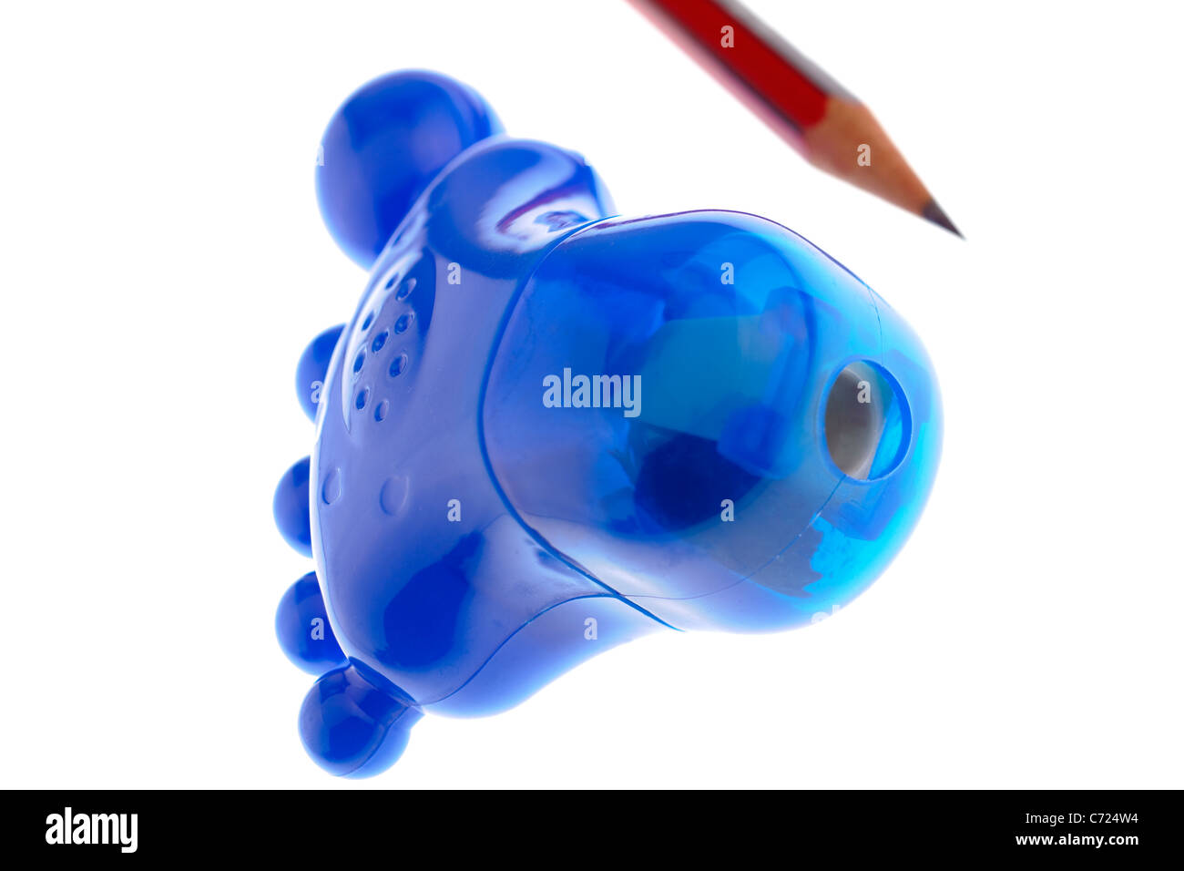 Blue foot shaped plastic pencil sharpener and sharpened pencil Stock Photo