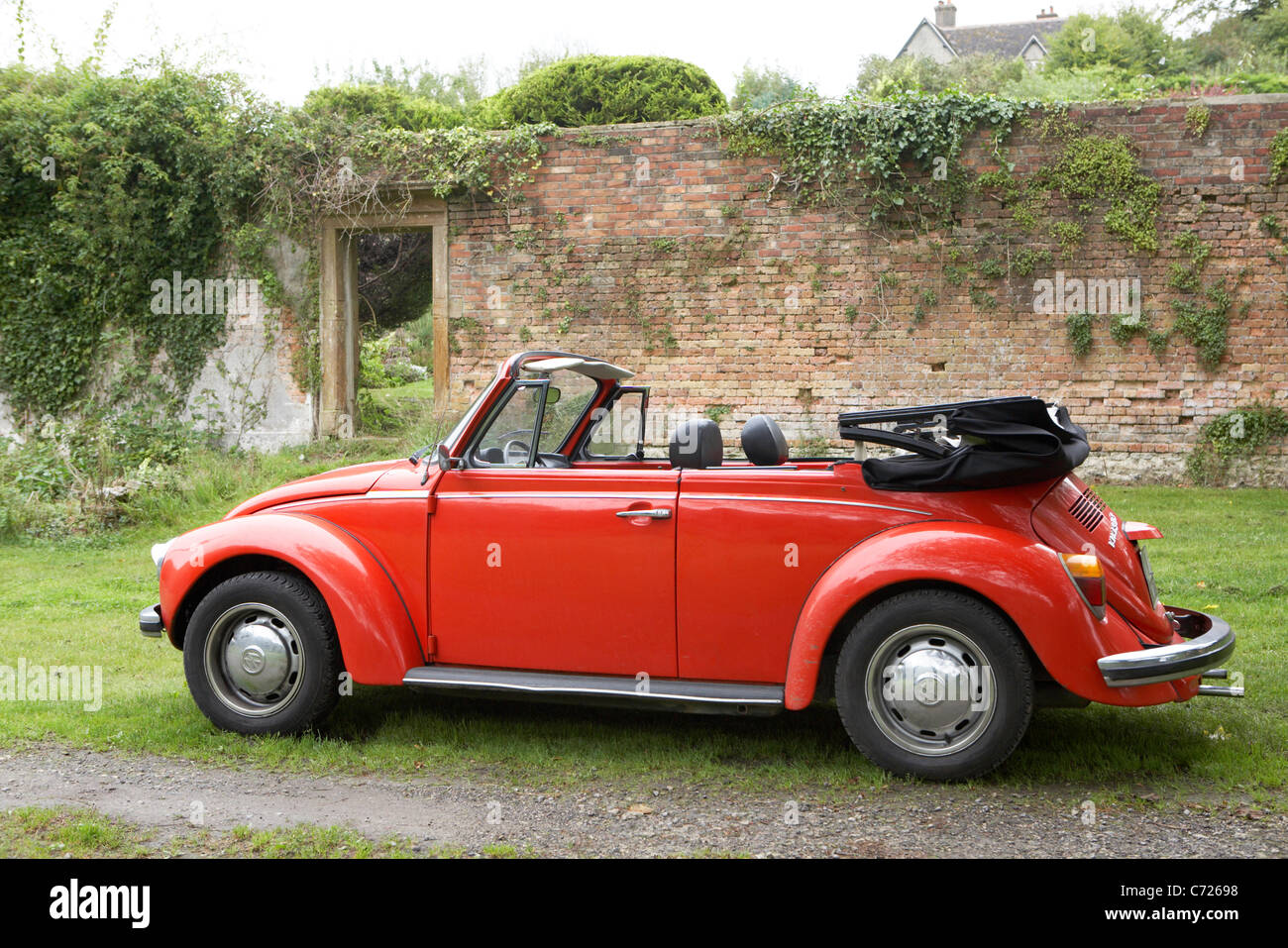 Celebrity chef Sarah Wieners classic red VW Beetle parked at Victorian walled garden in Dorset. Filmed  2011 for 2012 German TV. Stock Photo