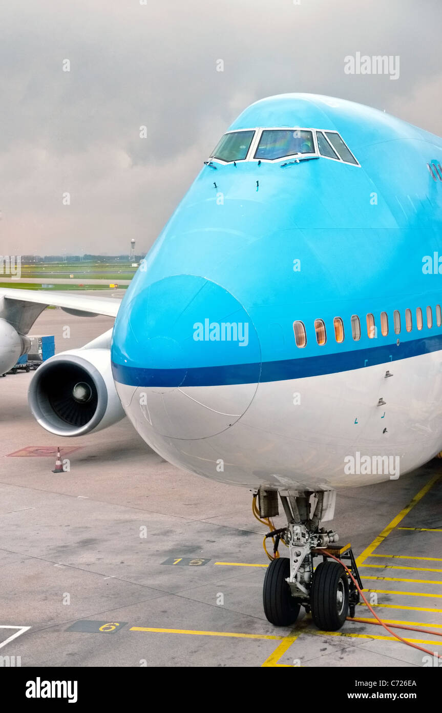 Blue and white landed aircraft docked in airport Stock Photo