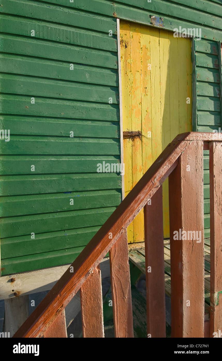 Wooden bathing hut wall, yellow door and banister details Stock Photo