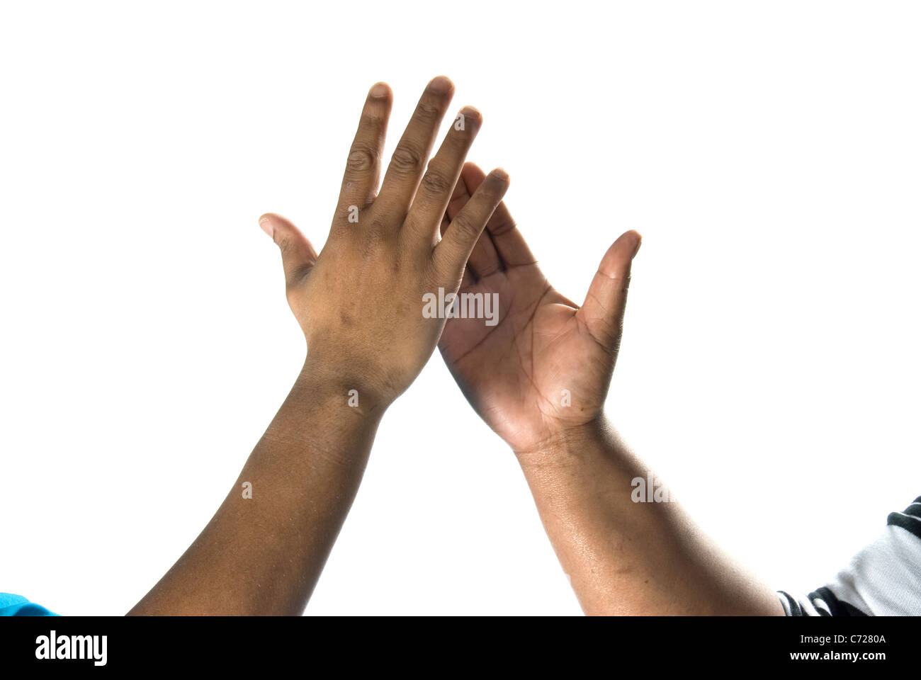 A studio shot of male and female African hands doing the high five gesture Stock Photo