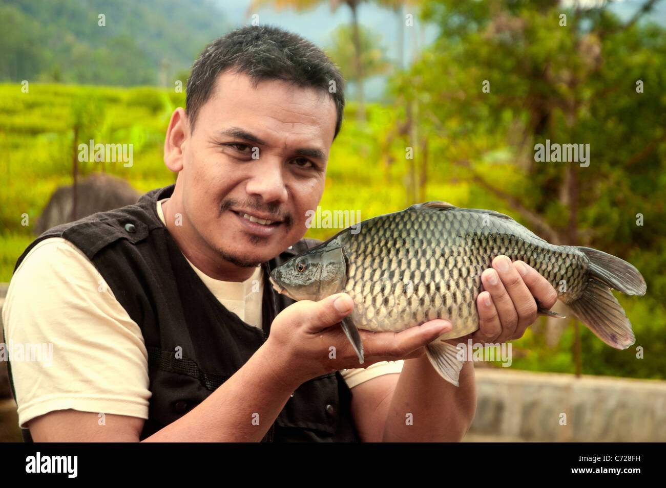 A Fisherman with the Common Carp Fish Stock Photo