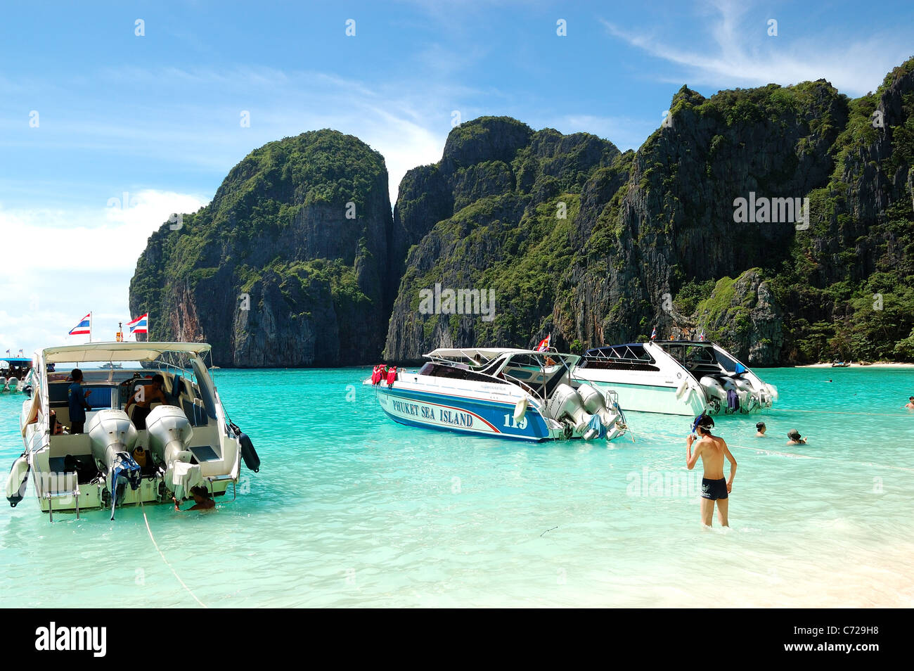 Motor boats on turquoise water of Maya Bay lagoon, Koh Phi Phi  island, Thailand Stock Photo