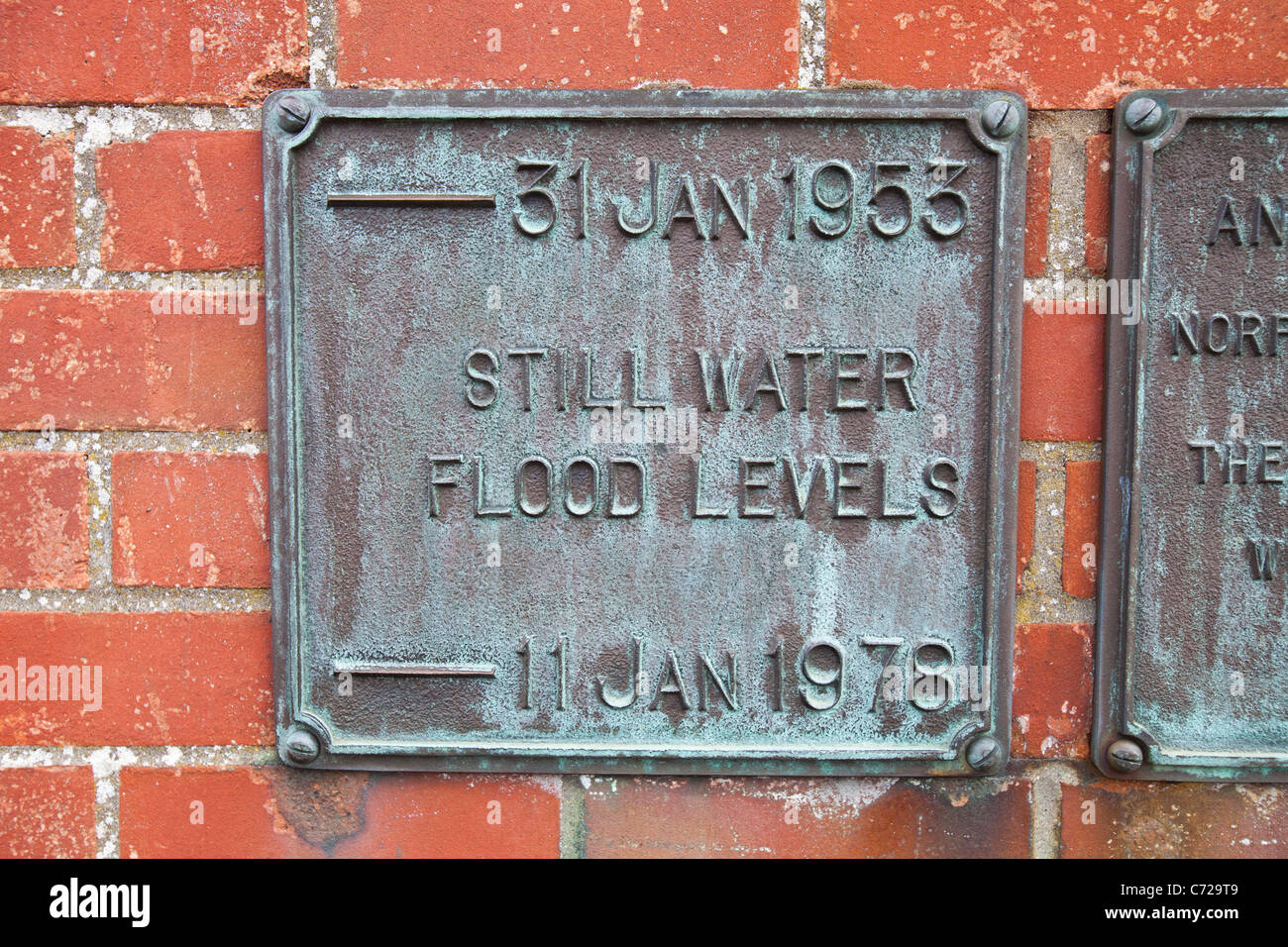 Flood levels marked on the sea defences in Wells Next the Sea in Norfolk, UK. Stock Photo