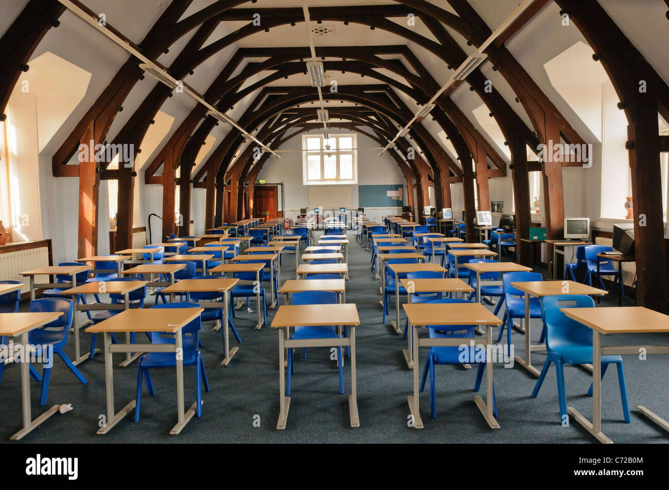 Large school classroom with desks and chairs in Campbell College, Belfast Stock Photo