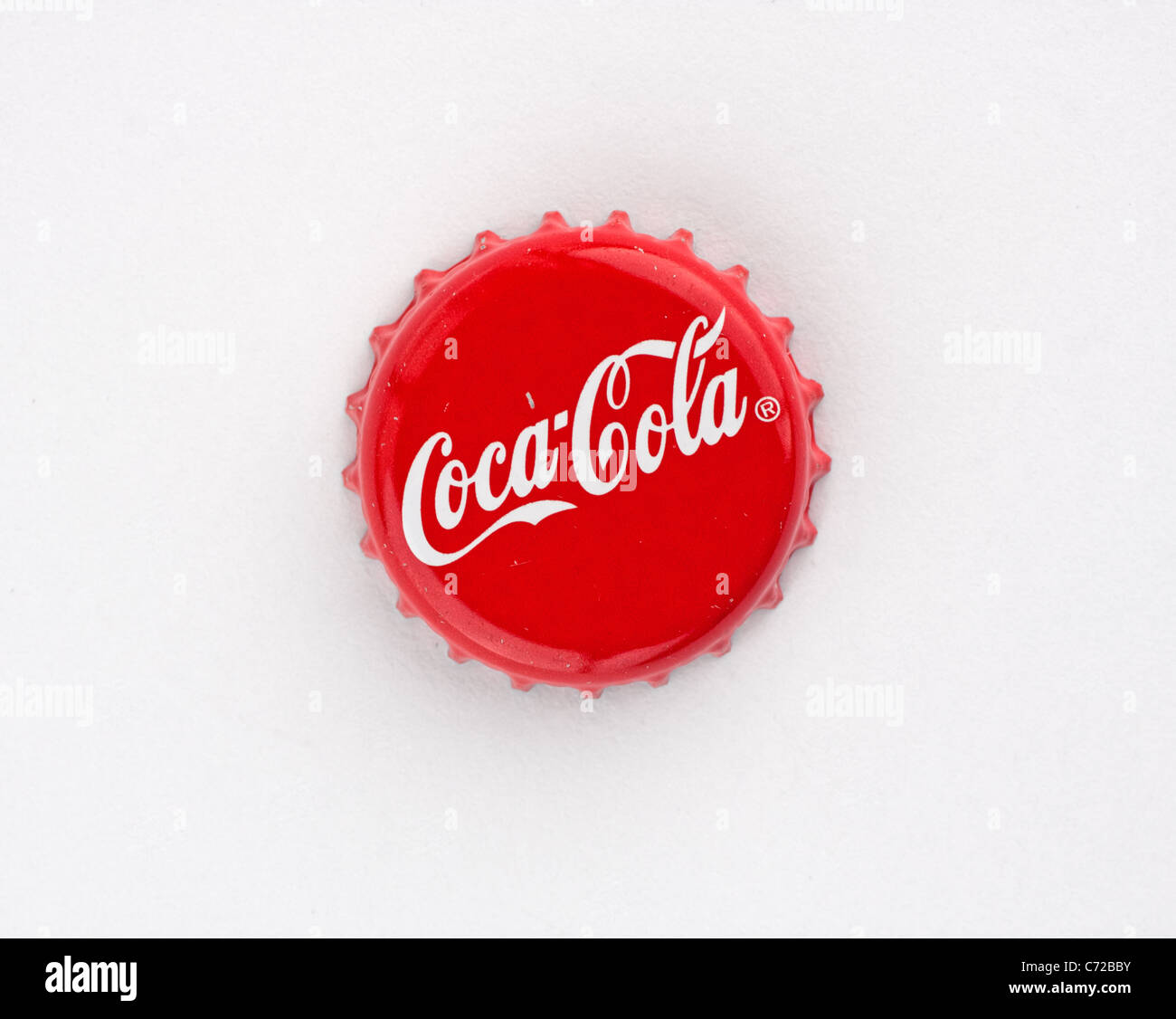 Muenster, Germany - September 10, 2011: Picture shows coca cola bottle cap on red background. Stock Photo
