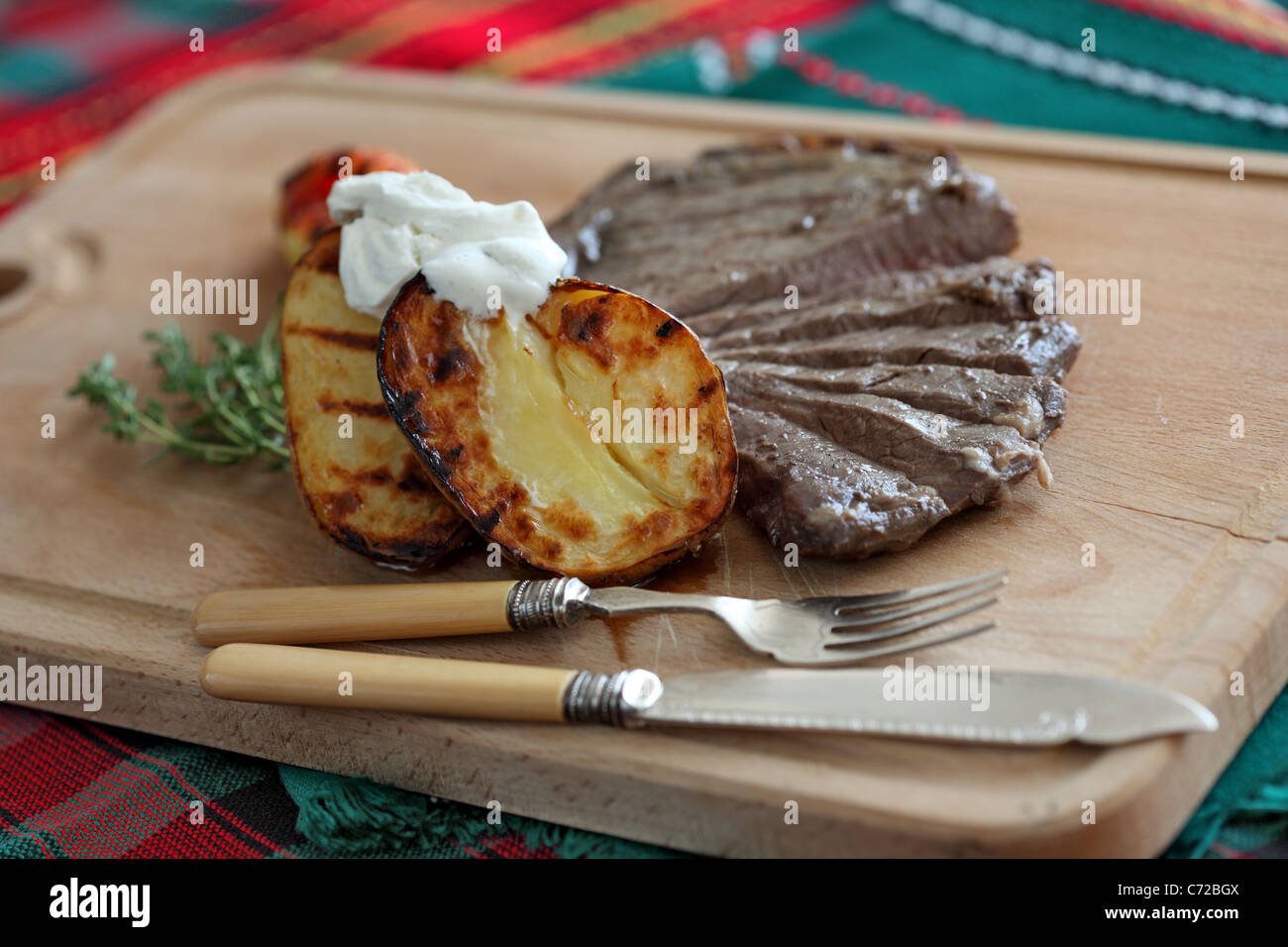 flank steak with baked potato Stock Photo Alamy