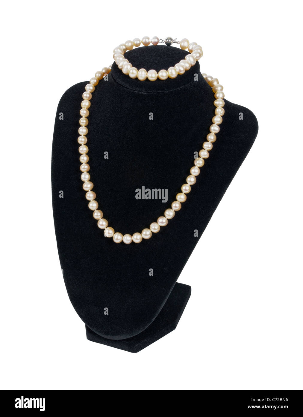 Pearl necklace and bracelet on a black velvet neck mold is an affordable luxury - path included Stock Photo