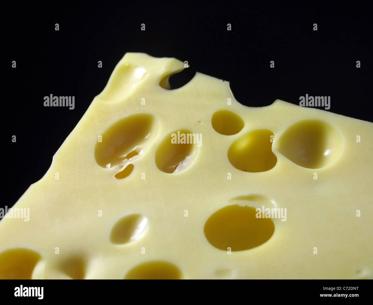 piece of cheese over black Stock Photo