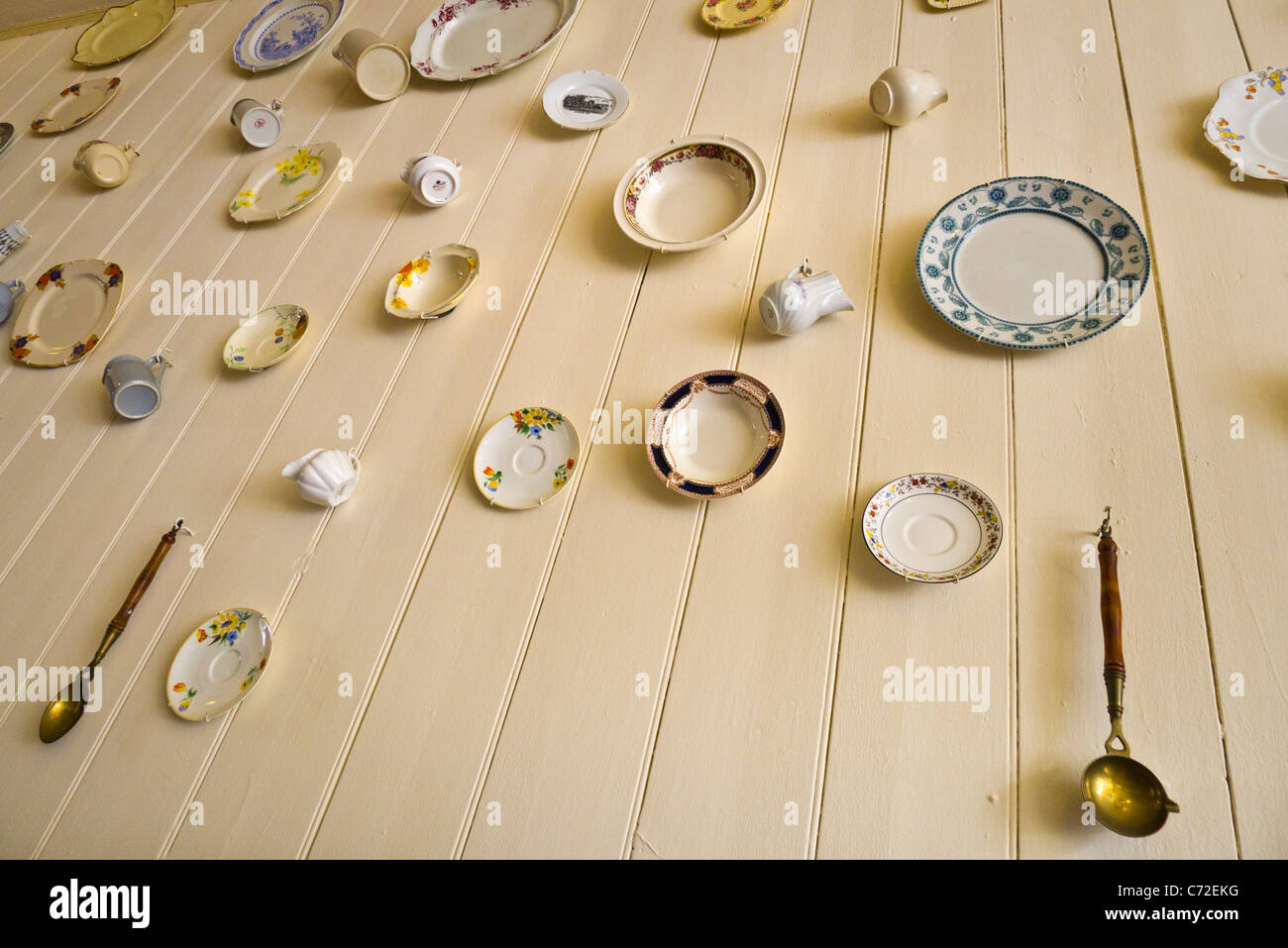 Plates hung to decorate the inside of a tea shop. Stock Photo