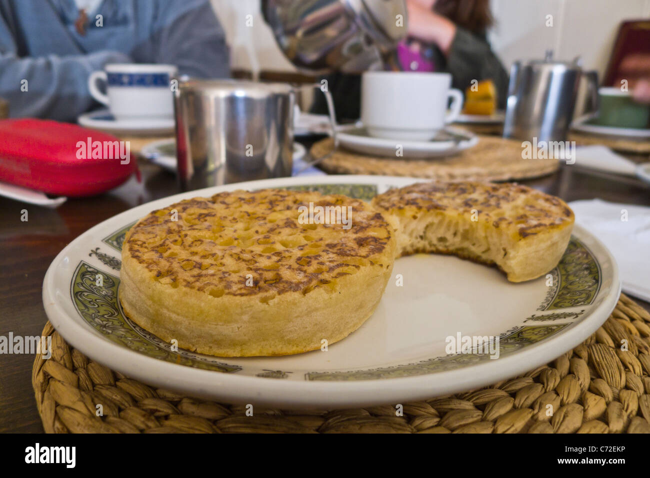 Crumpets on a plate in a teashop for afternoon tea. Stock Photo