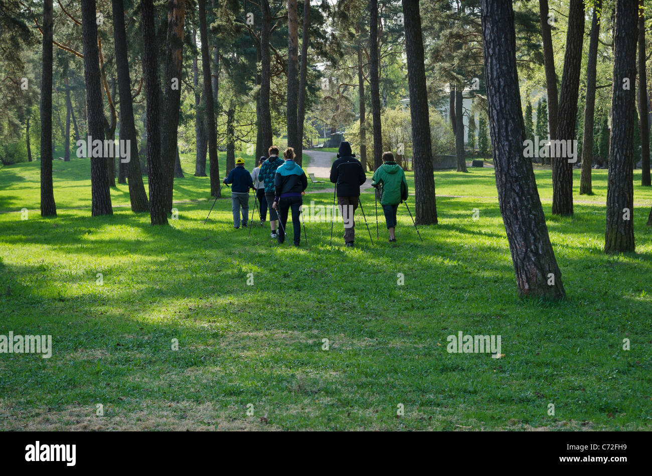 Finnish family out early morning Nordic Walking through the Hietaniemi area of Helsinki, Finland Stock Photo