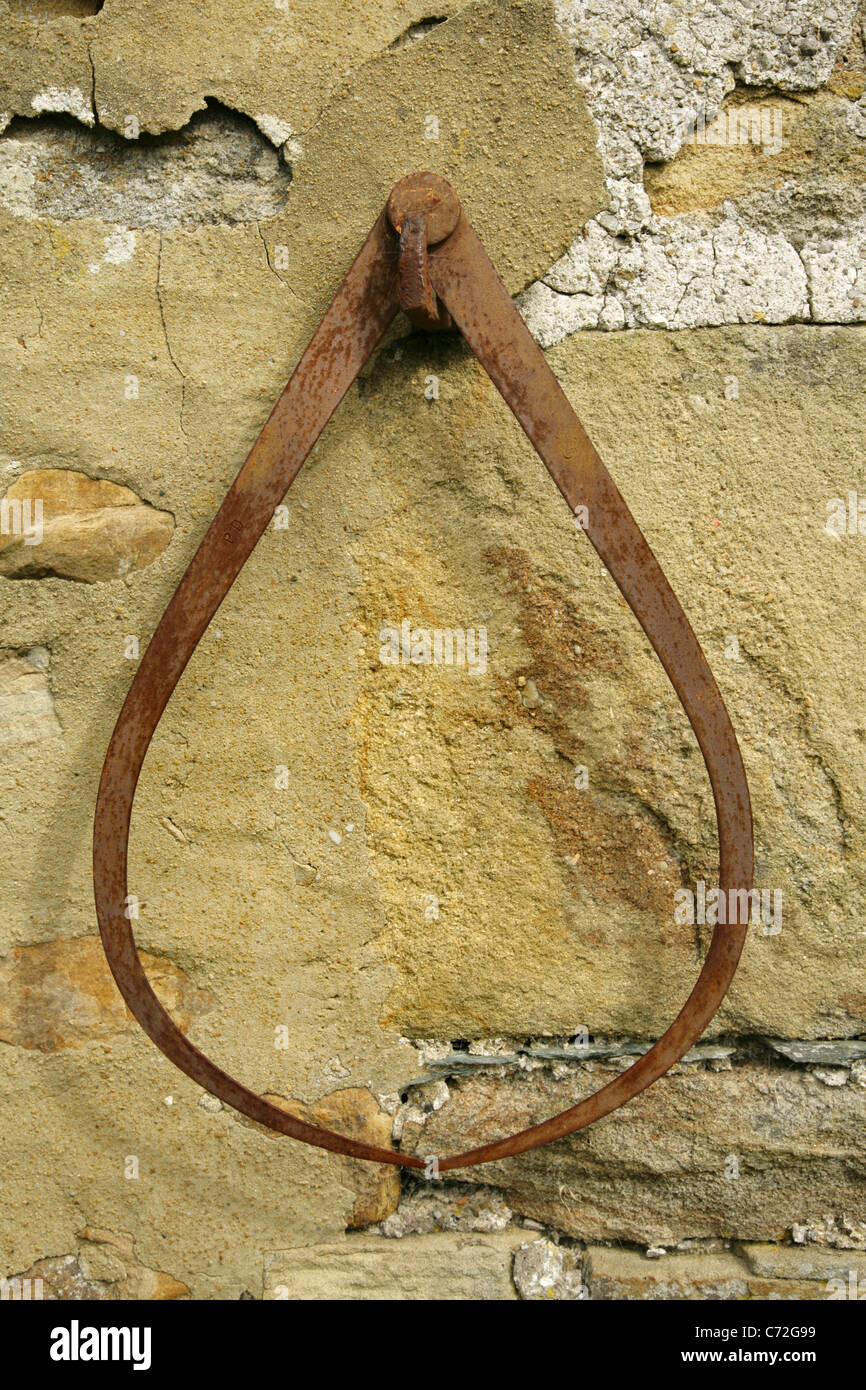 Rusty calipers hanging on stone wall Stock Photo Alamy
