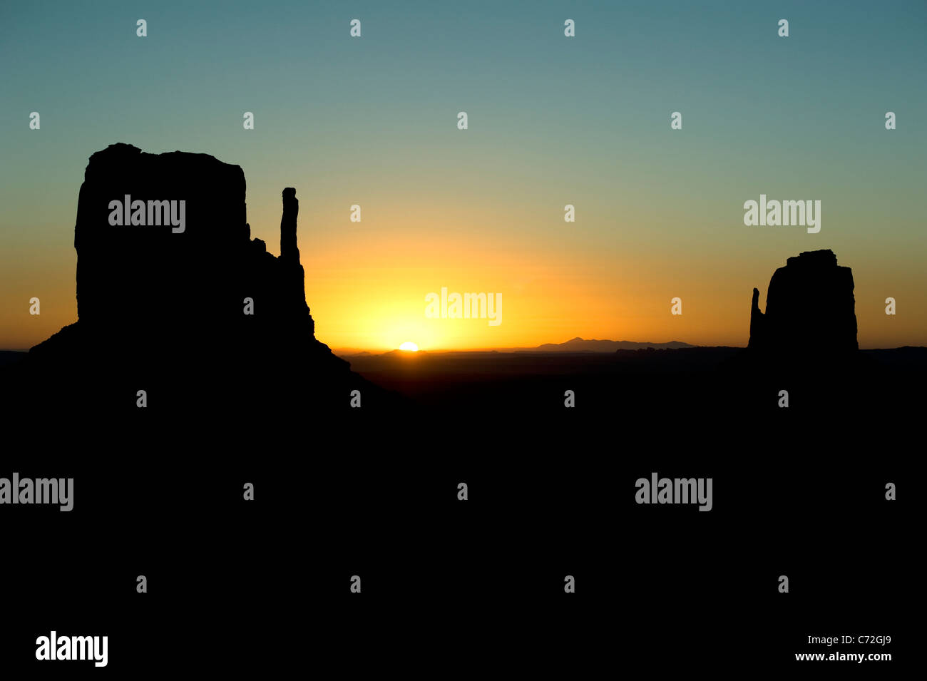 West and East Mitten Butte during sunrise in Monument Valley Navajo Tribal Park Arizona USA Stock Photo