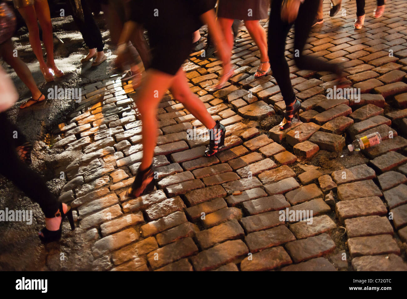 Fashionistas maneuver the cobblestone streets in their designer shoes