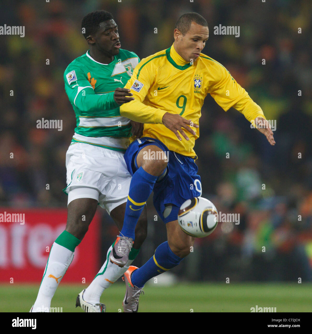Kolo Toure of Côte d'Ivoire (l) pressures Luis Fabiano of Brazil (r) during a 2010 FIFA World Cup soccer match June 20, 2010. Stock Photo