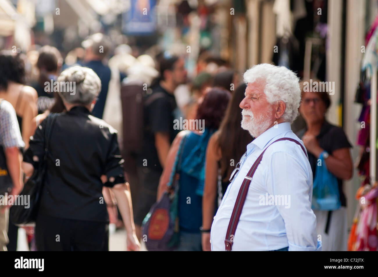 A local shop keeper looks on in busy shopping streets of Plaka, Athens, Greece. Stock Photo