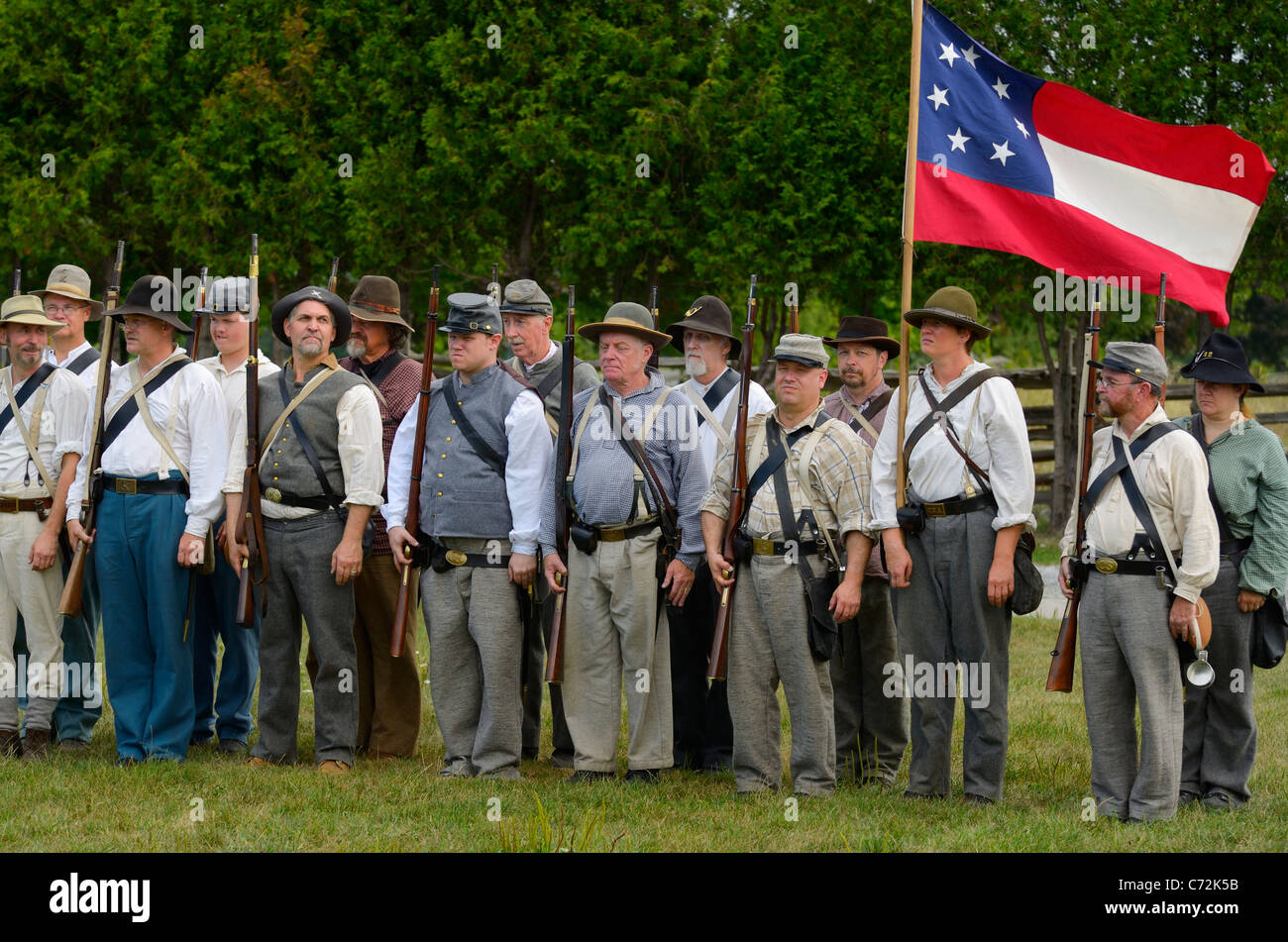 Company of conscripted Confederate soldiers with first seven star National flag American Civil war reenactment Country Heritage Park Milton Canada Stock Photo