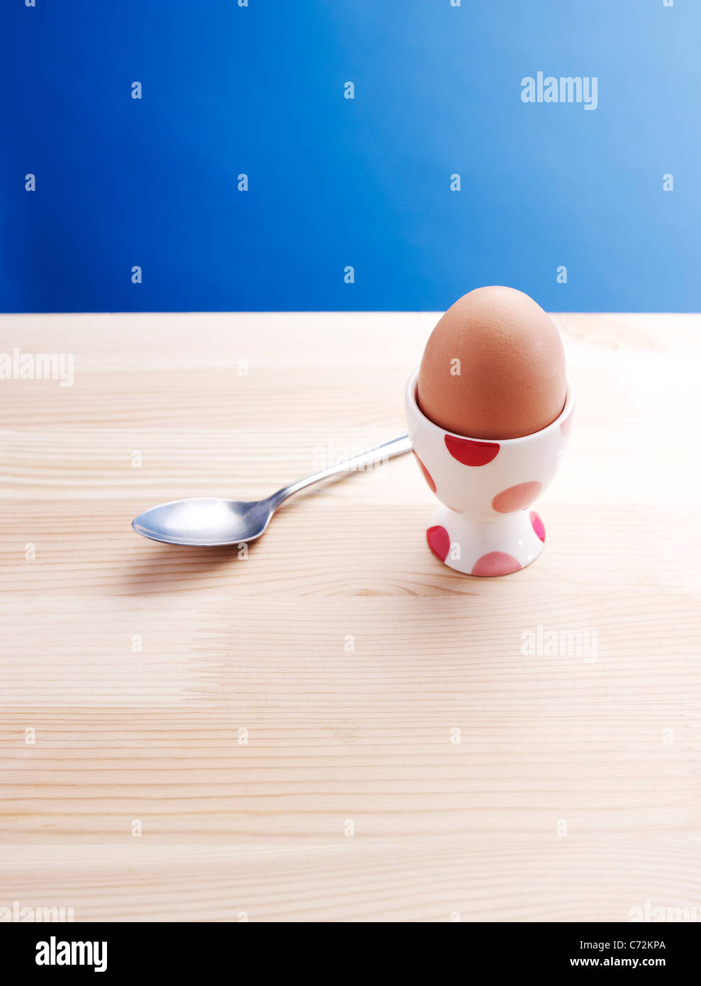 Boiled egg in an egg cup on a wooden table Stock Photo