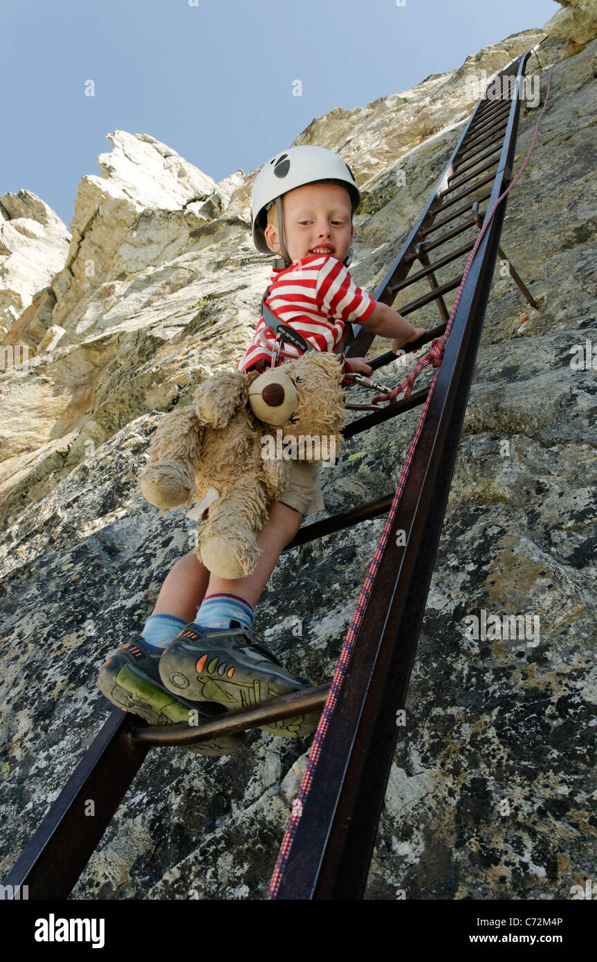 A young boy climbing down the ladders at the Pas de Chevres, Arolla,  Switzerland Stock Photo - Alamy