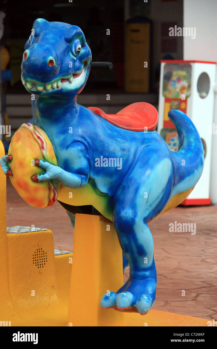 A dinosaur ride for kids to play on Stock Photo Alamy
