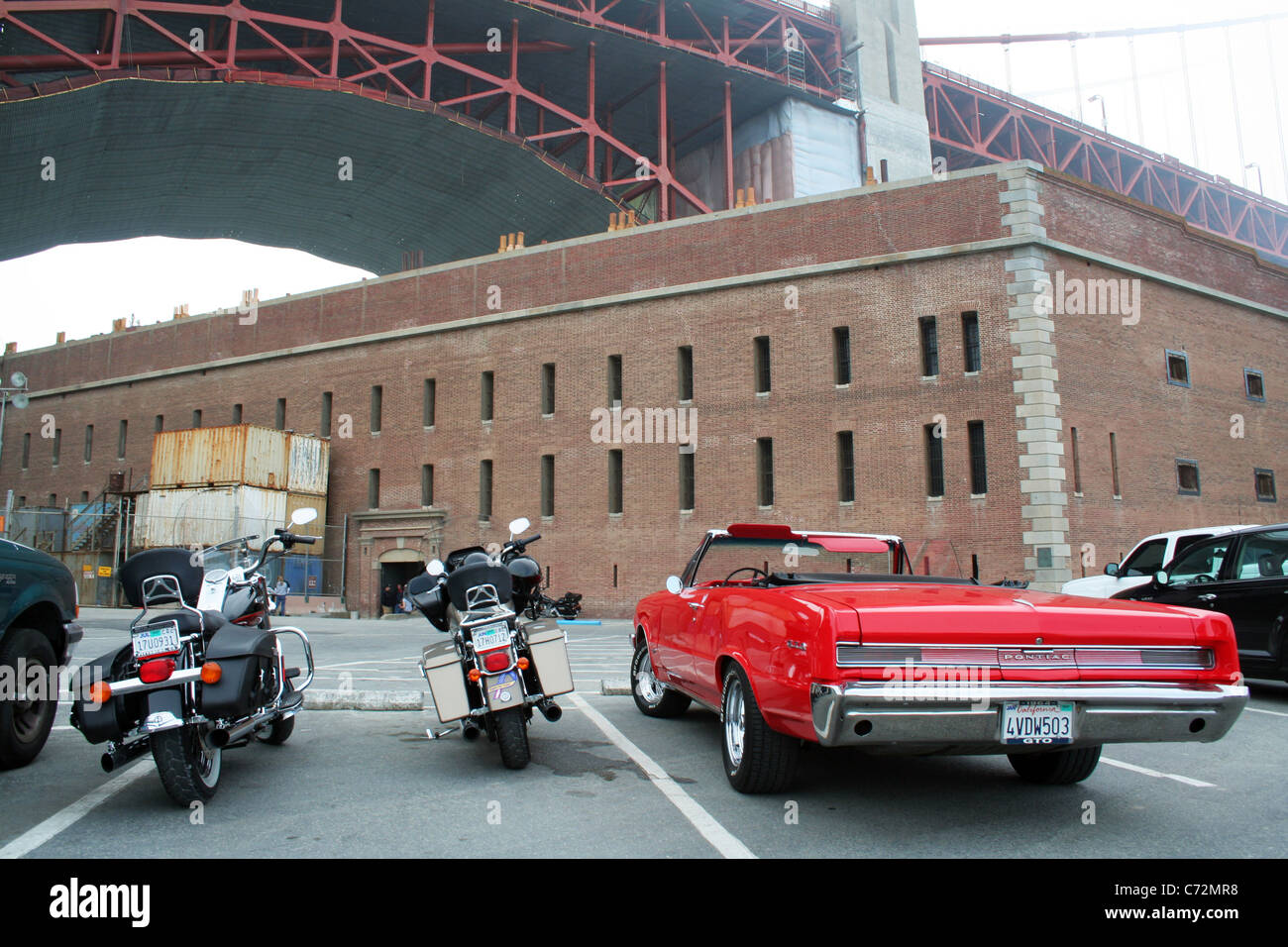 1964 Pontiac GTO at Fort Point under the Golden Gate bridge in San Francisco, California, USA. Stock Photo
