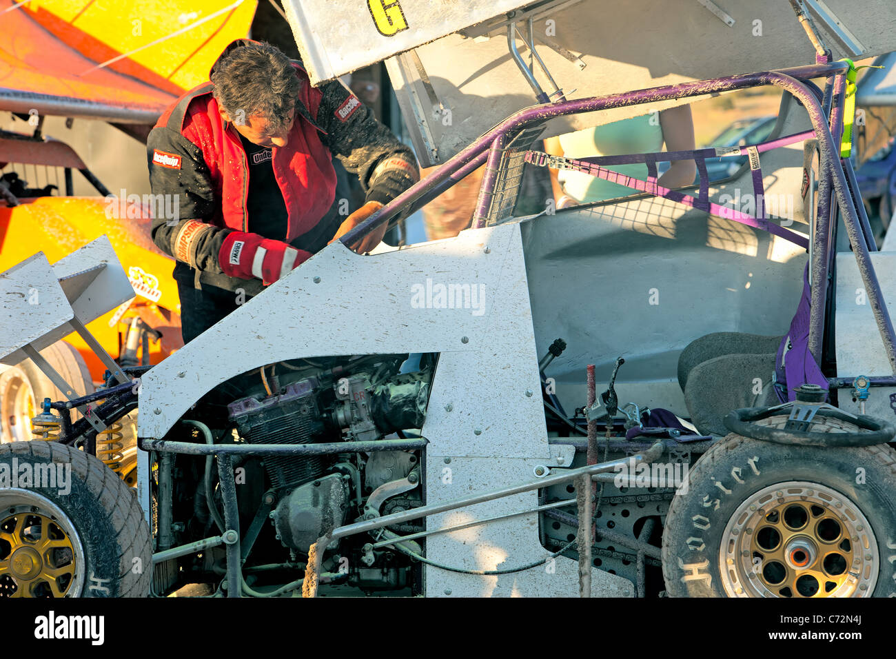 Race cars sprint driver working on his race car before race. High speed