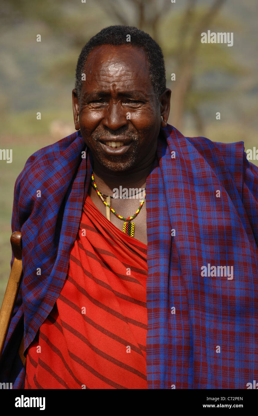 Africa.Tanzania. 5 march 2009. Maasai village. Portrait elderly maasai. Village maasai in savanna. A shining sun. Stock Photo