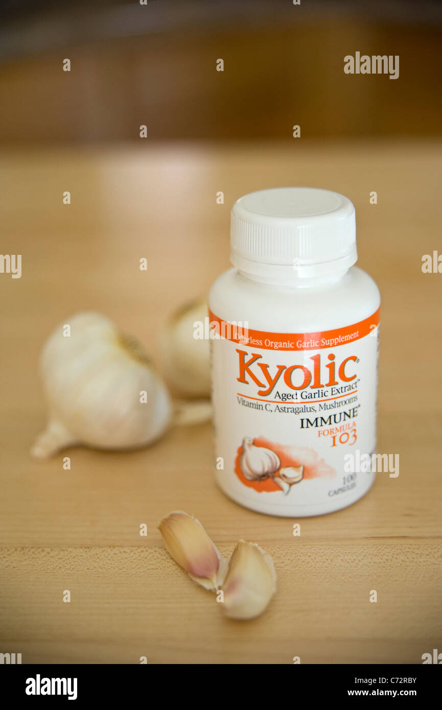 Aged Garlic capsules in a still life arrangement with garlic cloves