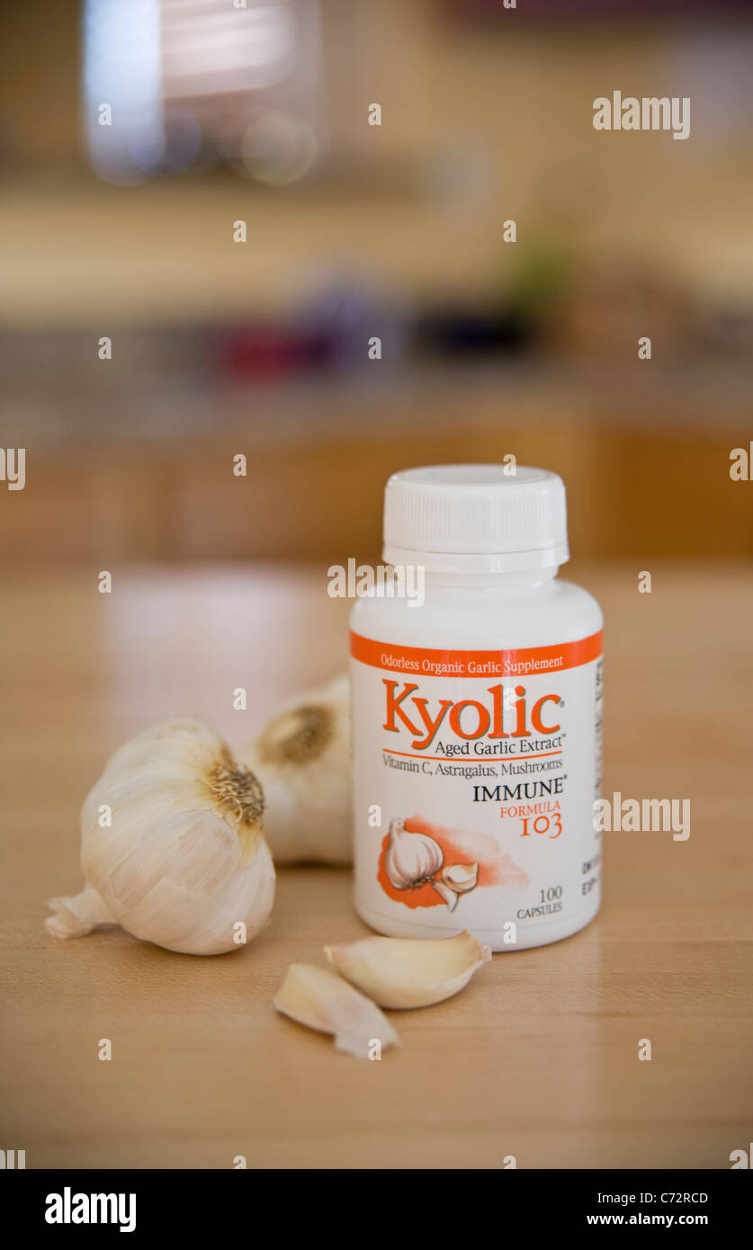 Aged Garlic capsules in a still life arrangement with garlic cloves